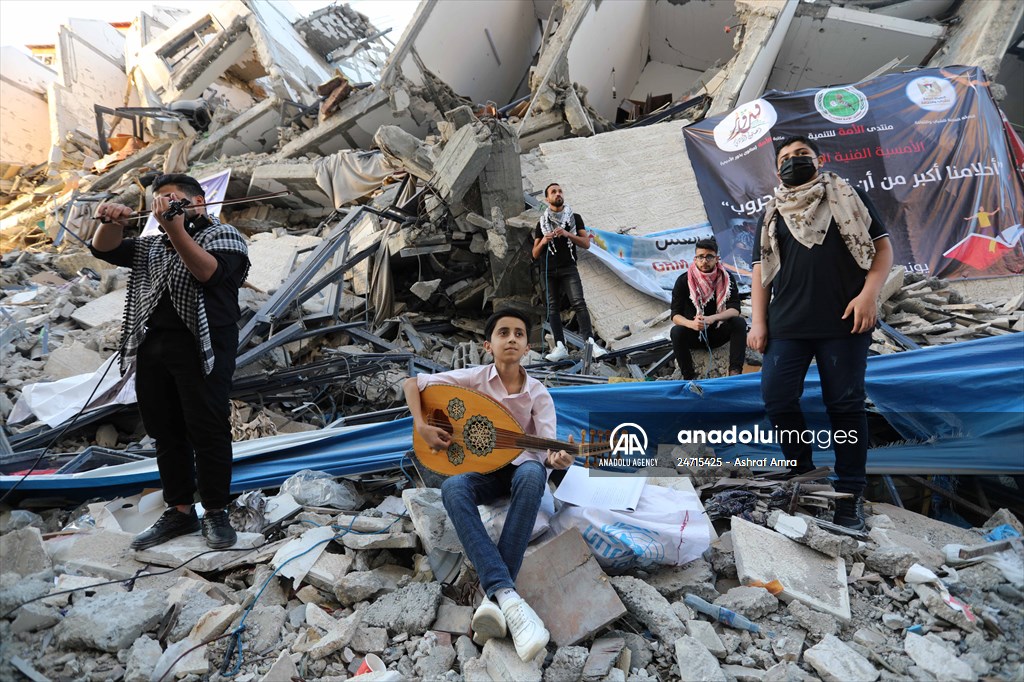 Palestinian musicians in Gaza perform concert in front of debris of buildings