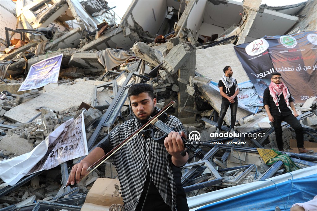Palestinian musicians in Gaza perform concert in front of debris of buildings