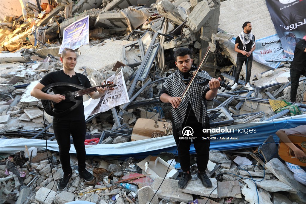 Palestinian musicians in Gaza perform concert in front of debris of buildings