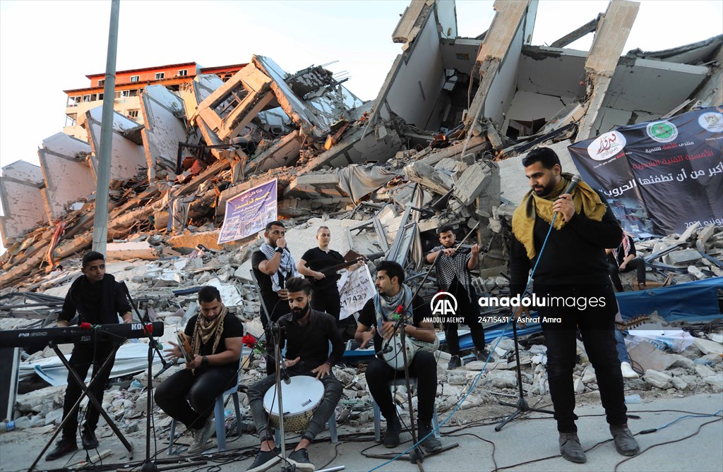 Palestinian musicians in Gaza perform concert in front of debris of buildings