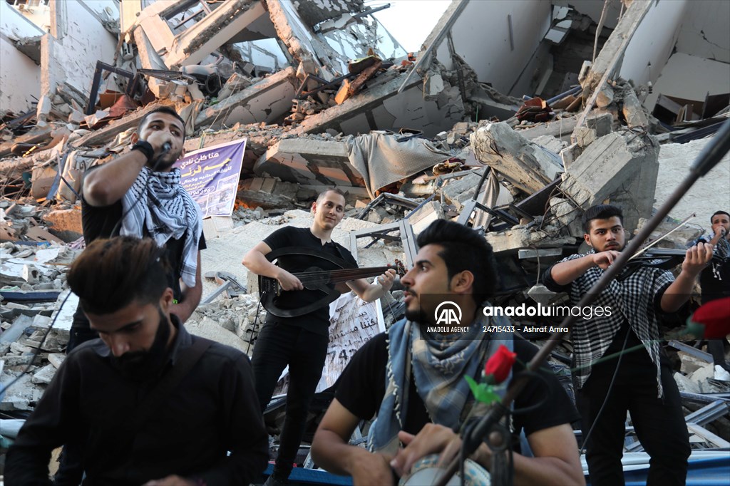 Palestinian musicians in Gaza perform concert in front of debris of buildings