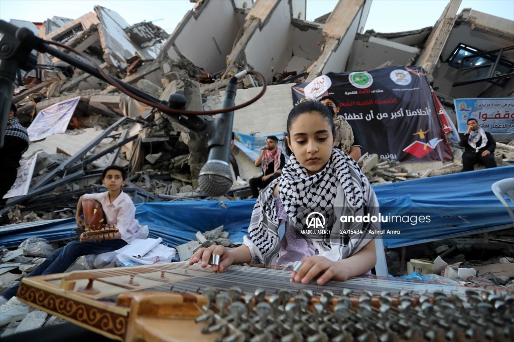 Palestinian musicians in Gaza perform concert in front of debris of buildings