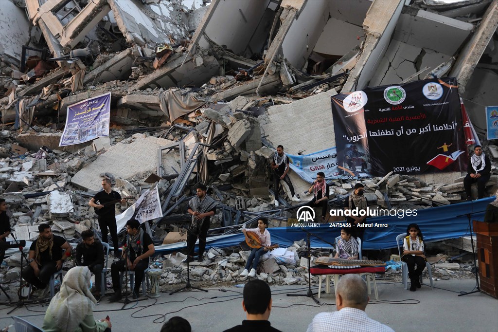 Palestinian musicians in Gaza perform concert in front of debris of buildings
