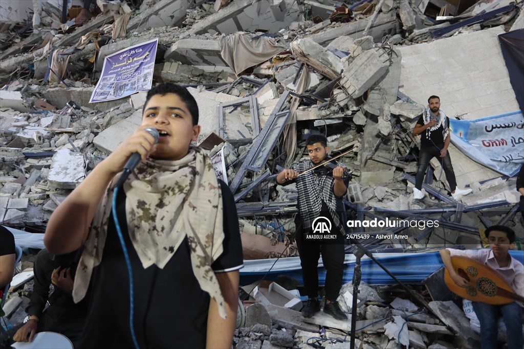 Palestinian musicians in Gaza perform concert in front of debris of buildings