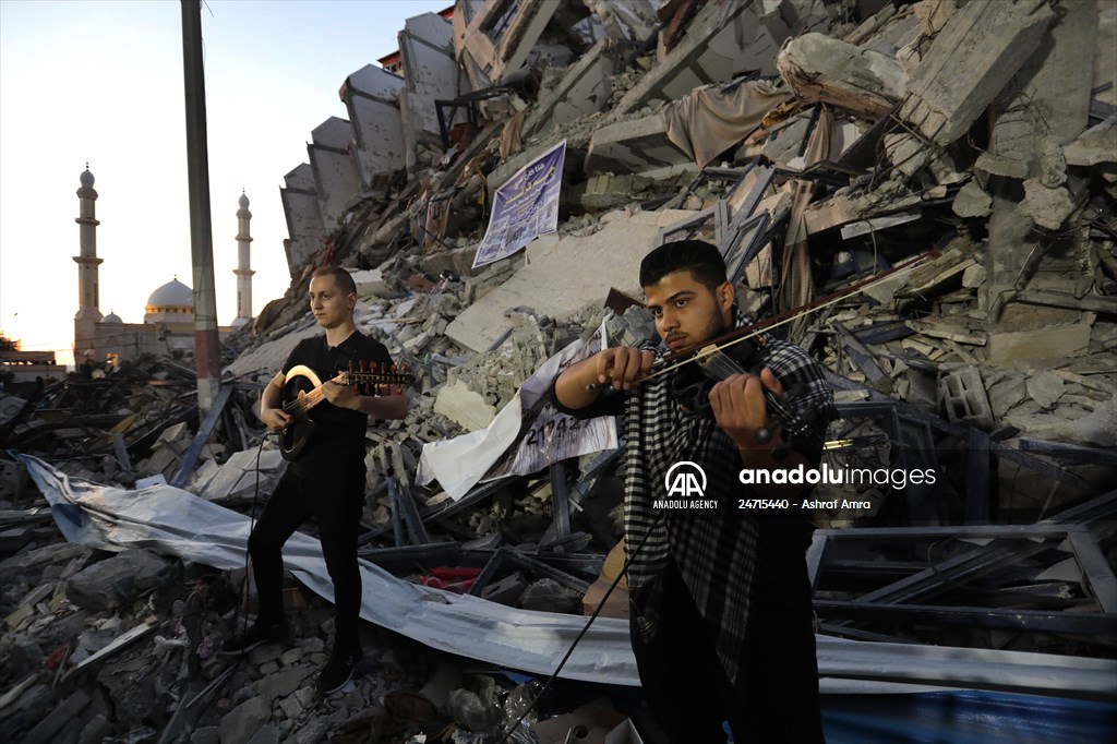 Palestinian musicians in Gaza perform concert in front of debris of buildings