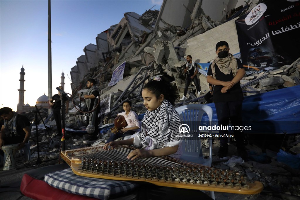 Palestinian musicians in Gaza perform concert in front of debris of buildings