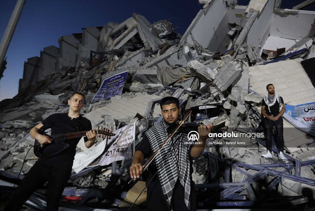 Palestinian musicians in Gaza perform concert in front of debris of buildings