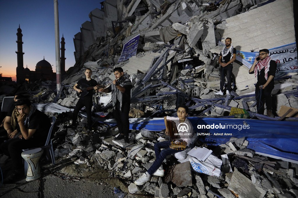 Palestinian musicians in Gaza perform concert in front of debris of buildings