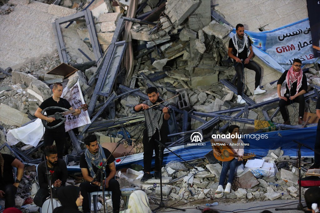 Palestinian musicians in Gaza perform concert in front of debris of buildings