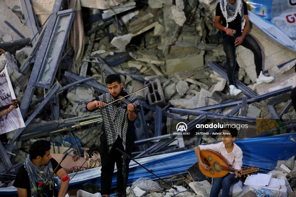 Palestinian musicians in Gaza perform concert in front of debris of buildings
