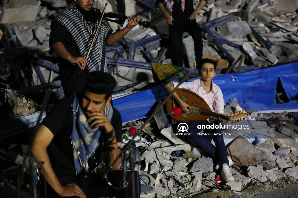 Palestinian musicians in Gaza perform concert in front of debris of buildings