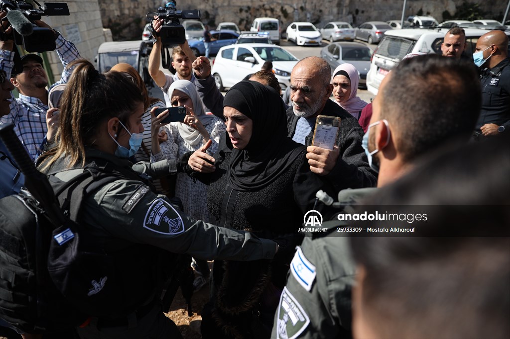 Palestinian mother reacts on her son's grave to Israel's works to turn part of cemetery into a park