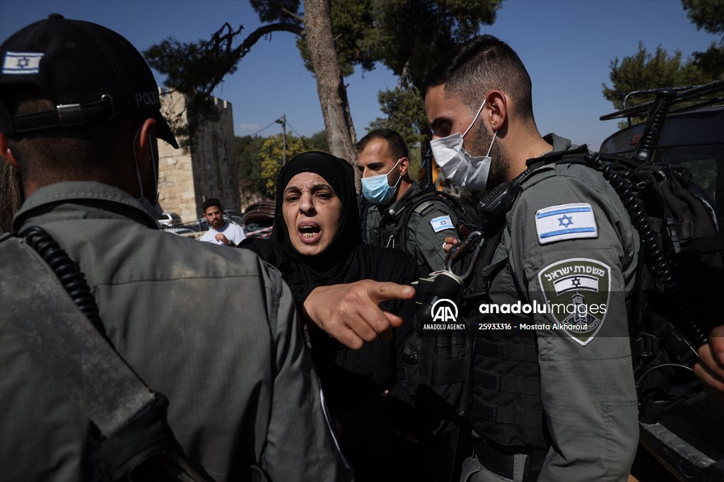 Palestinian mother reacts on her son's grave to Israel's works to turn part of cemetery into a park