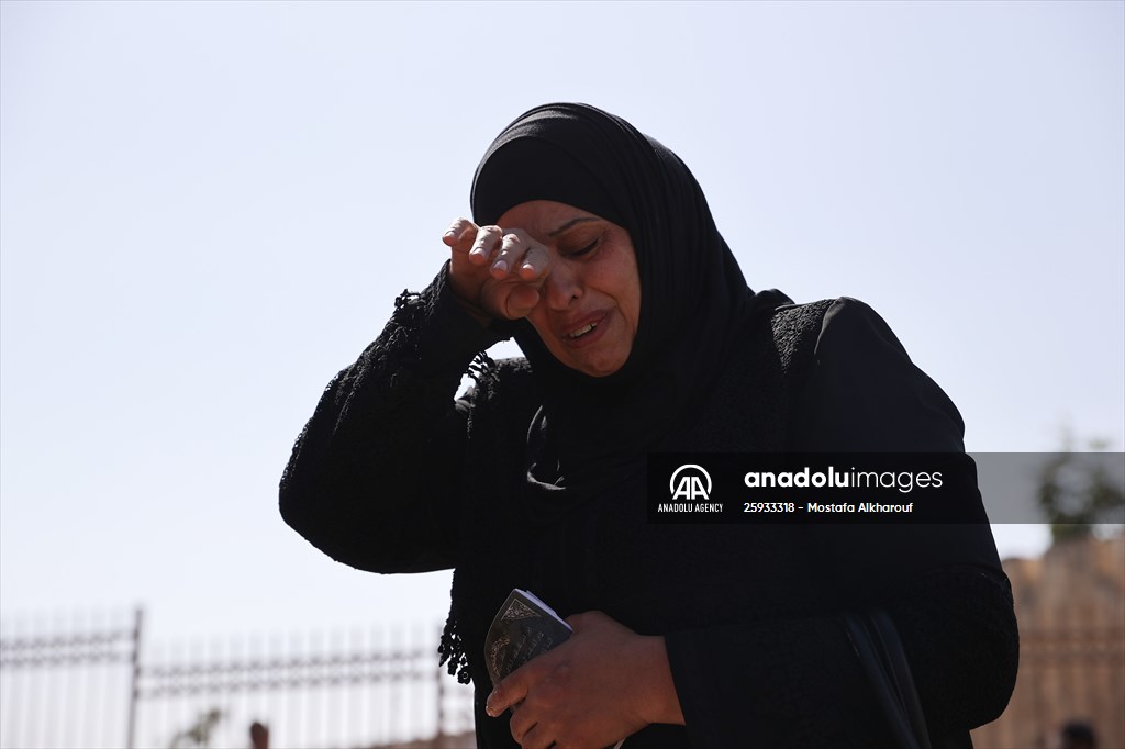 Palestinian mother reacts on her son's grave to Israel's works to turn part of cemetery into a park