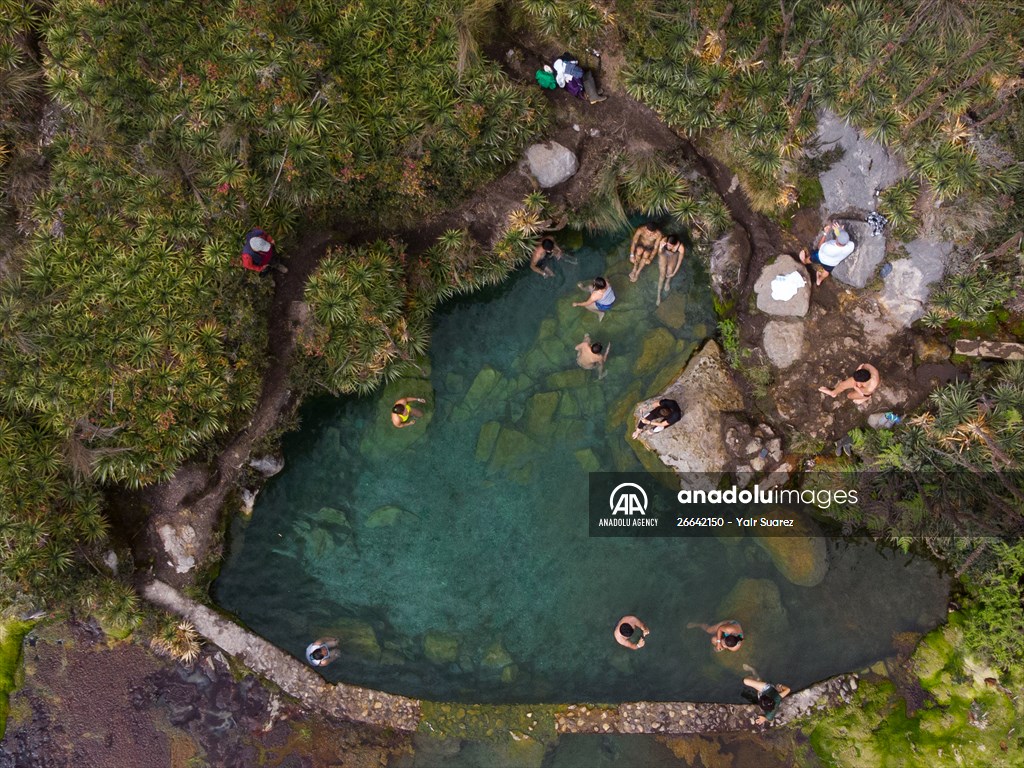 Tourists ascend to the hot springs lagoons of the Nevado del Rui