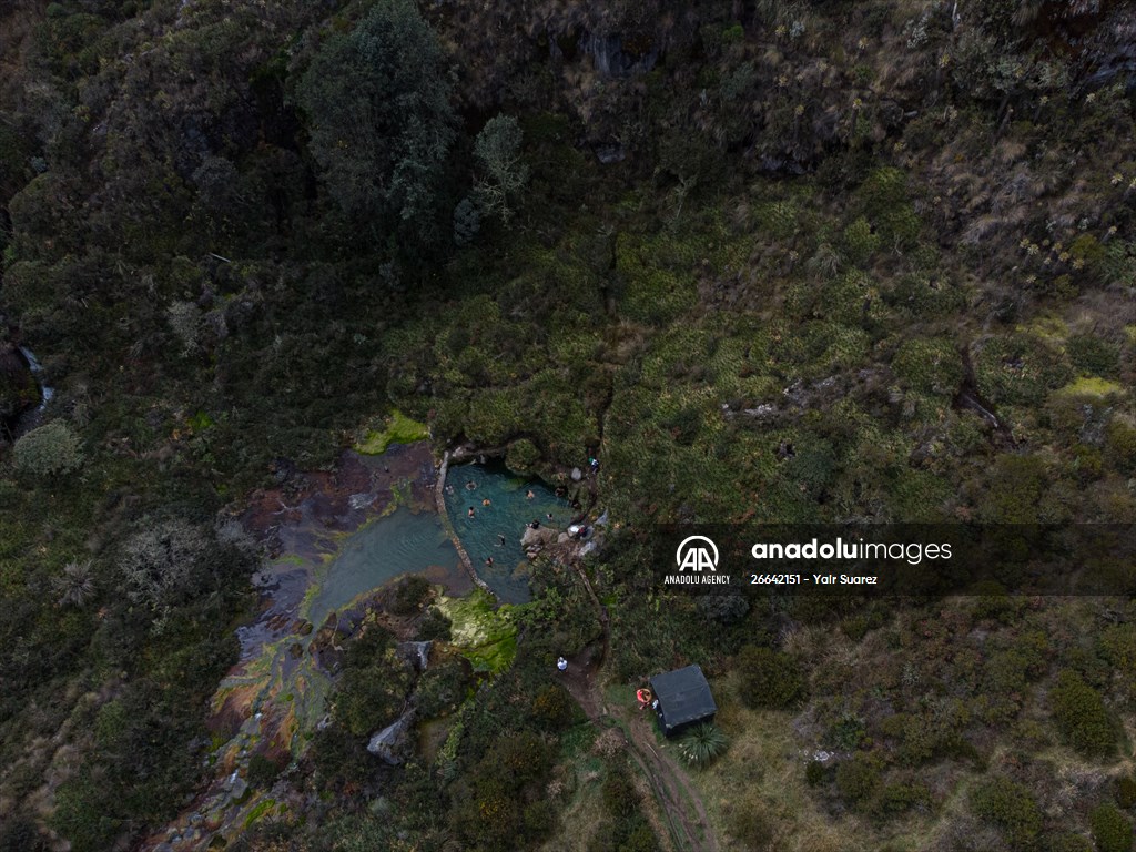 Tourists ascend to the hot springs lagoons of the Nevado del Rui