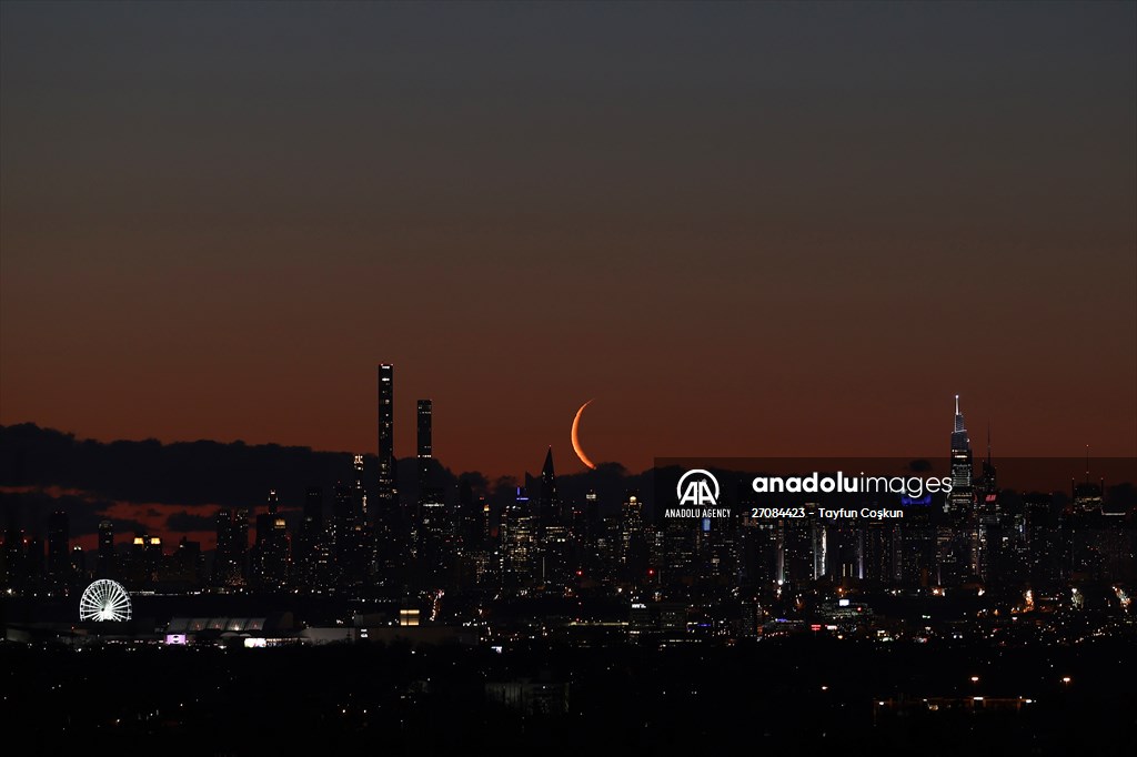 Crescent moon rises over New York City