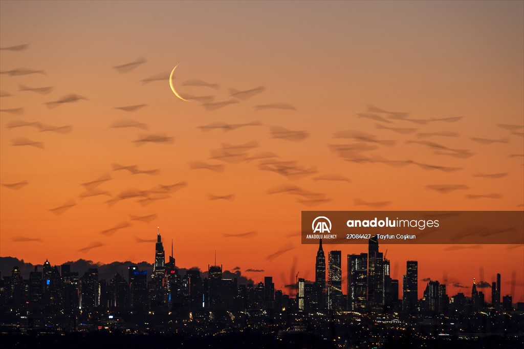 Crescent moon rises over New York City