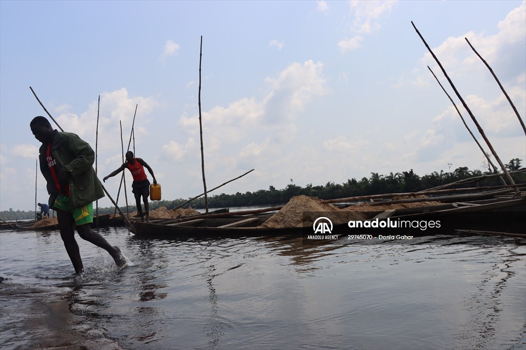 Cameroonian young people work under Sanaga River