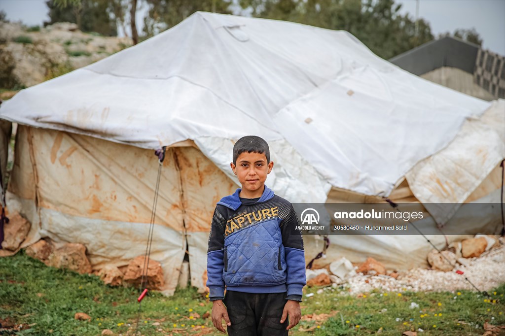 Syrian children after 12th anniversary of the Syrian Civil War at the tent city in Idlib