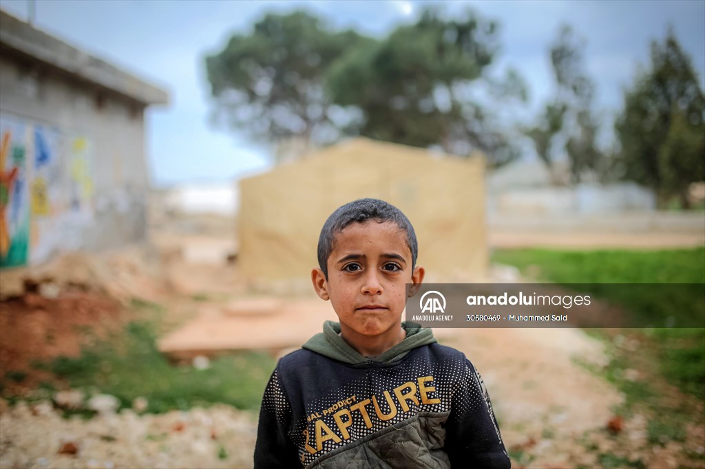 Syrian children after 12th anniversary of the Syrian Civil War at the tent city in Idlib