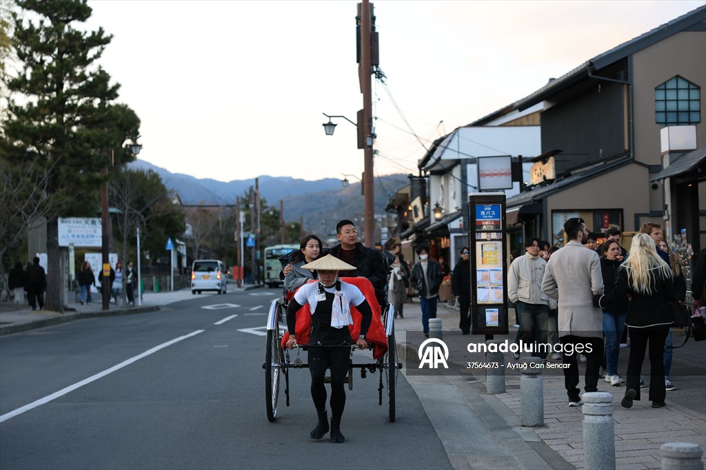 Fushimi Inari Shrine in Kyoto welcomes tourists and locals, reflecting daily life