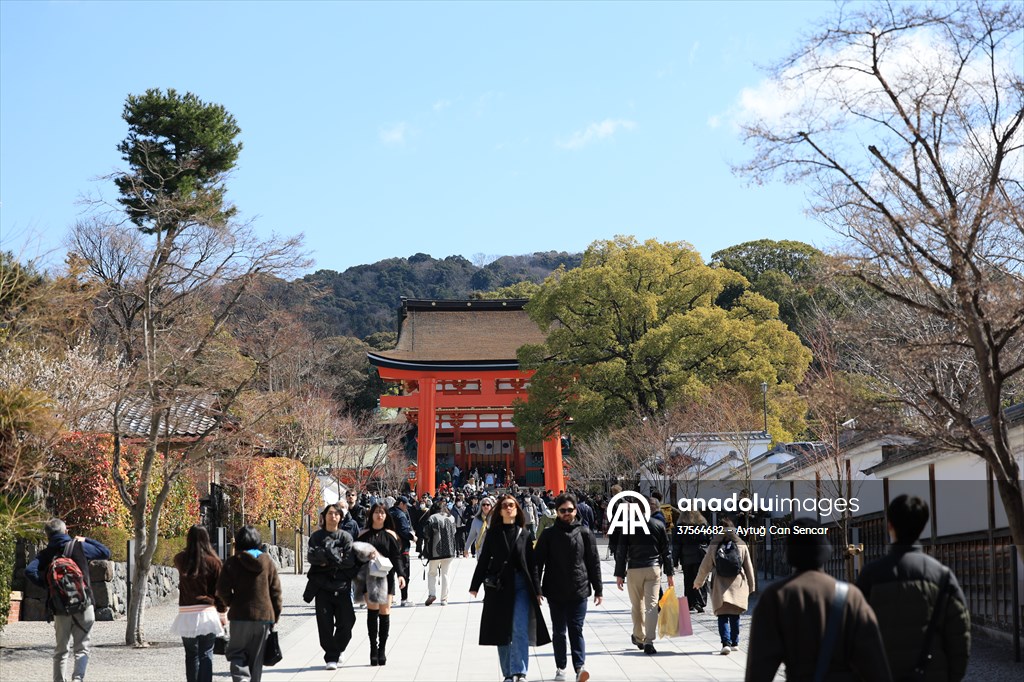 Fushimi Inari Shrine in Kyoto welcomes tourists and locals, reflecting daily life