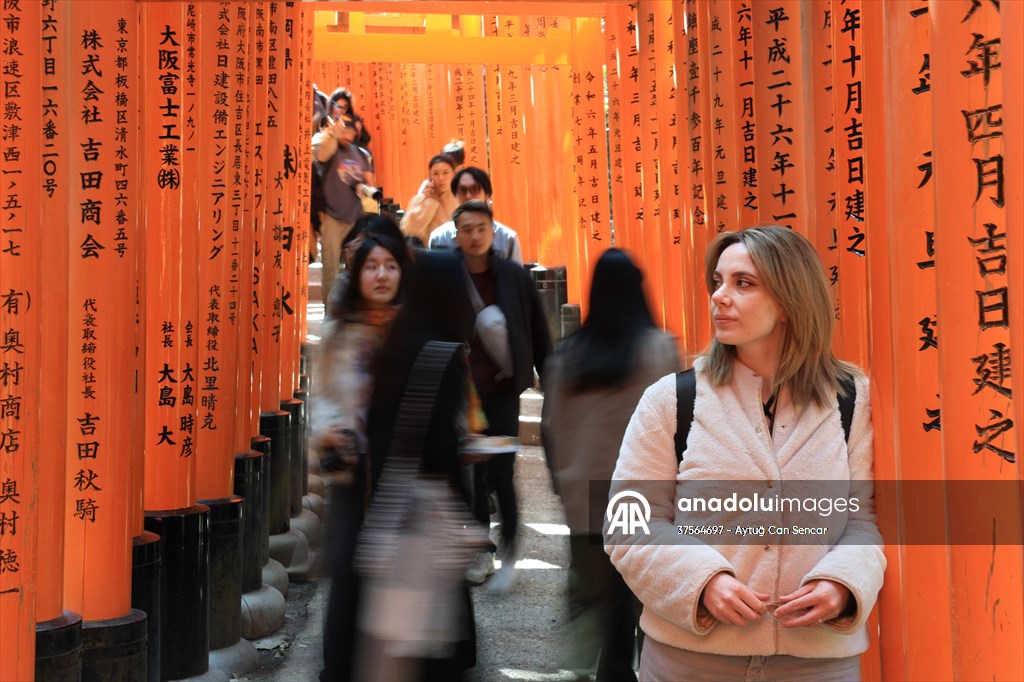 Fushimi Inari Shrine in Kyoto welcomes tourists and locals, reflecting daily life