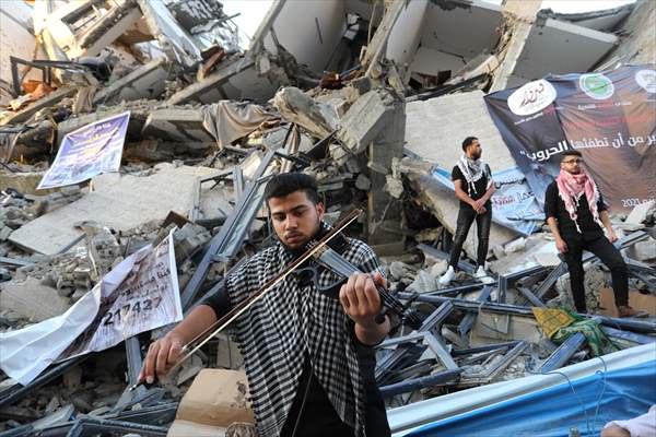 Palestinian musicians in Gaza perform concert in front of debris of buildings