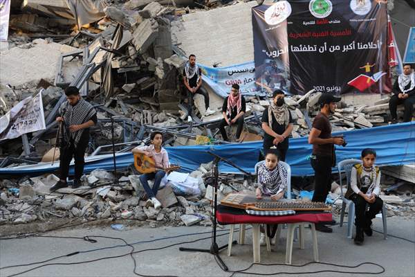 Palestinian musicians in Gaza perform concert in front of debris of buildings