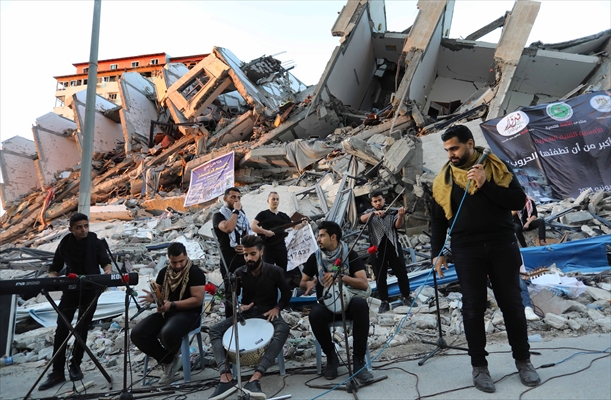 Palestinian musicians in Gaza perform concert in front of debris of buildings