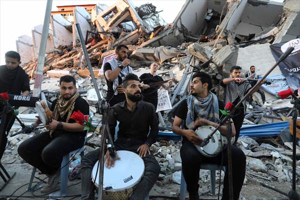 Palestinian musicians in Gaza perform concert in front of debris of buildings