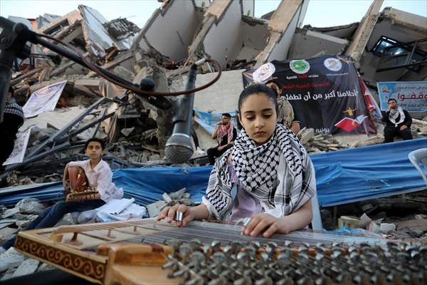 Palestinian musicians in Gaza perform concert in front of debris of buildings