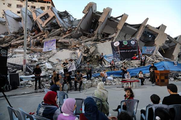 Palestinian musicians in Gaza perform concert in front of debris of buildings