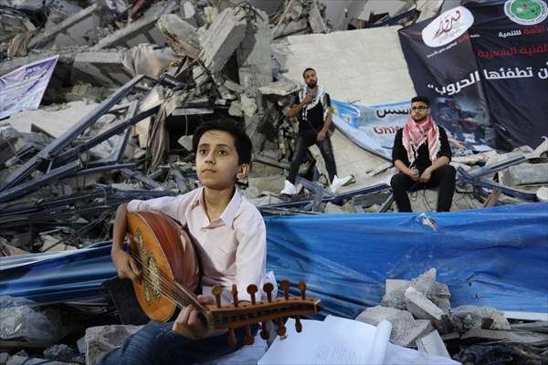 Palestinian musicians in Gaza perform concert in front of debris of buildings