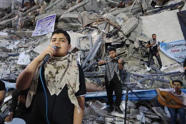 Palestinian musicians in Gaza perform concert in front of debris of buildings