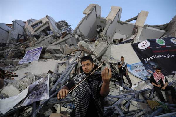 Palestinian musicians in Gaza perform concert in front of debris of buildings