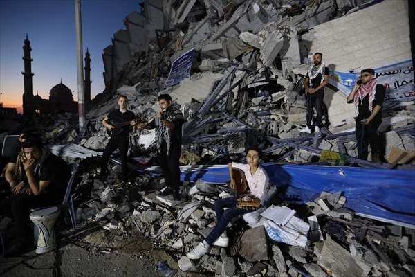 Palestinian musicians in Gaza perform concert in front of debris of buildings
