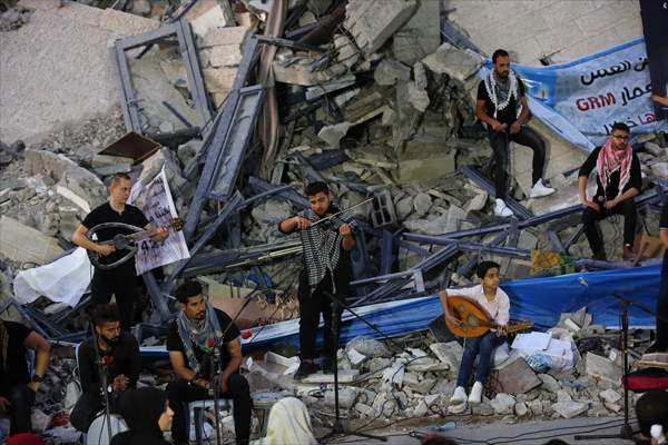 Palestinian musicians in Gaza perform concert in front of debris of buildings