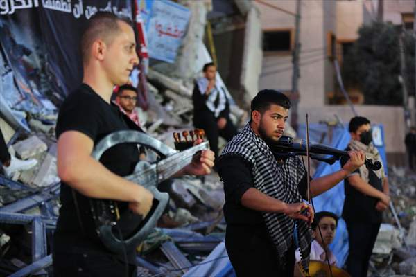 Palestinian musicians in Gaza perform concert in front of debris of buildings