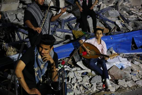 Palestinian musicians in Gaza perform concert in front of debris of buildings