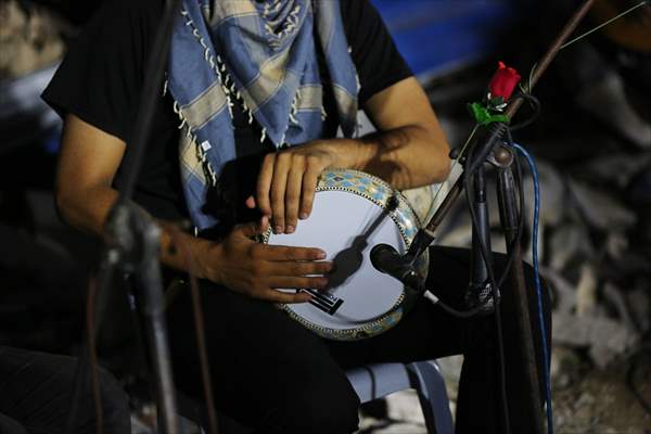 Palestinian musicians in Gaza perform concert in front of debris of buildings