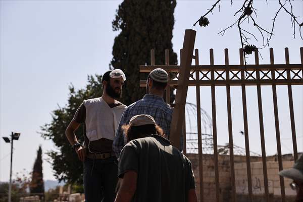 Palestinian mother reacts on her son's grave to Israel's works to turn part of cemetery into a park