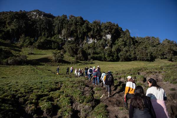 Tourists ascend to the hot springs lagoons of the Nevado del Rui