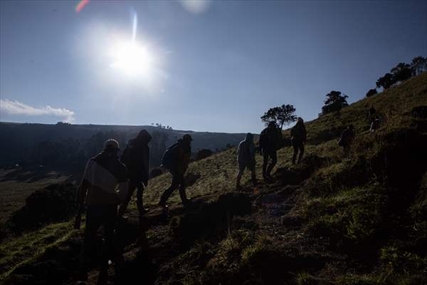 Tourists ascend to the hot springs lagoons of the Nevado del Rui