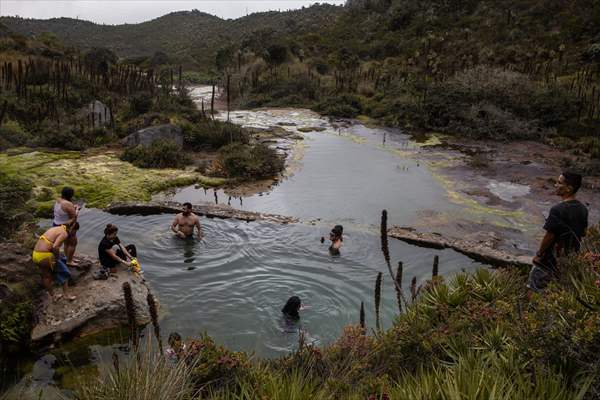 Tourists ascend to the hot springs lagoons of the Nevado del Rui