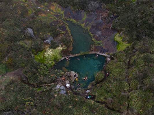 Tourists ascend to the hot springs lagoons of the Nevado del Rui