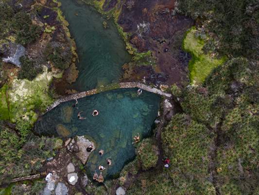 Tourists ascend to the hot springs lagoons of the Nevado del Rui