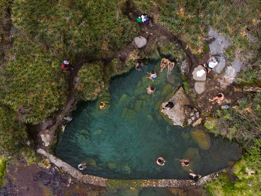 Tourists ascend to the hot springs lagoons of the Nevado del Rui