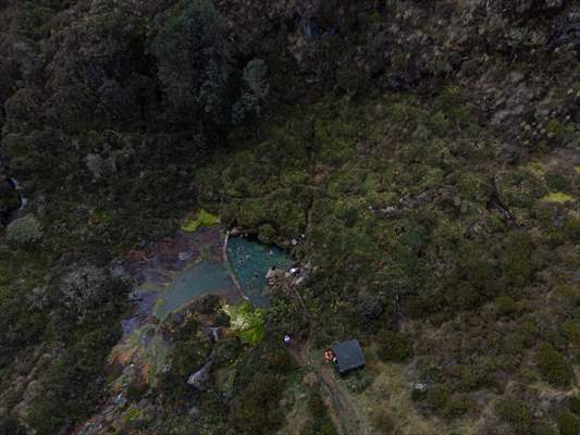 Tourists ascend to the hot springs lagoons of the Nevado del Rui